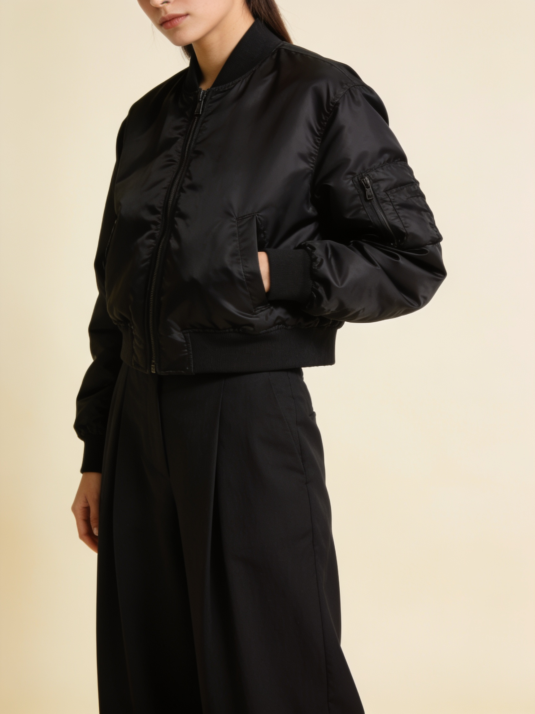 Model wearing the cropped nylon bomber in black