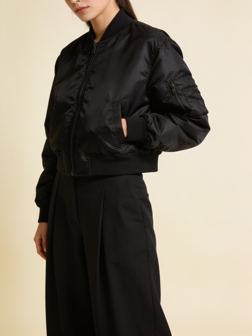 Model wearing the cropped nylon bomber in black